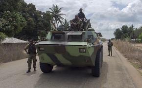 FILE - In this image made from video, Mozambican soldiers ride on an armored vehicle in a convoy driving to Mocimboa da Praia, Cabo Delgado province, Mozambique, Aug. 9, 2021. (AP Photo/Marc Hoogsteyns, file)