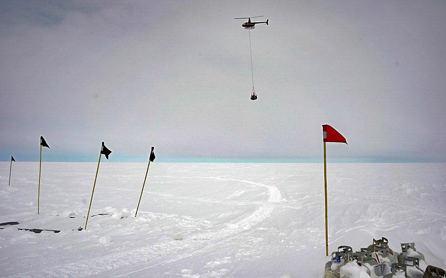 A helicopter is used to transfer supplies from the Winkie drill camp to the ASIG drill camp. 