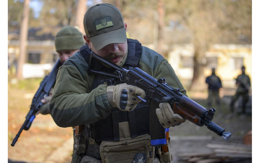 Andrey Kashlakov, a member of the Ukrainian Territorial Defense Forces, rushes through a mock building as part of room clearance training provided by U.S. military veterans at a site outside Kyiv, Ukraine, on Nov. 2, 2022. 