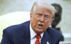 Donald Trump, seen from the chest up, speaks in the Oval Office of the White House.