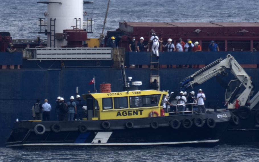 Russian, Ukrainian, Turkish and U.N. officials arrive to the cargo ship Razoni for inspection while it is anchored at the entrance of the Bosphorus Strait in Istanbul, Turkey, Wednesday, Aug. 3, 2022. The Sierra Leone-flagged Razoni, loaded up with 26,000 tons of corn, is the first cargo ship to leave Ukraine since the Russian invasion, and set sail from Odesa Monday, August 1, 2022. Its final destination is Lebanon.