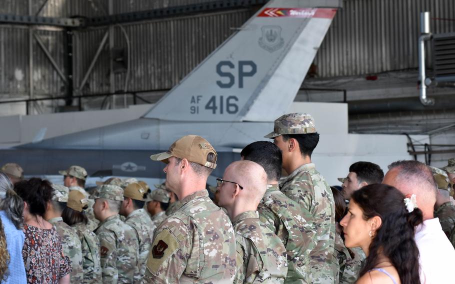 People standing in front of an air craft.