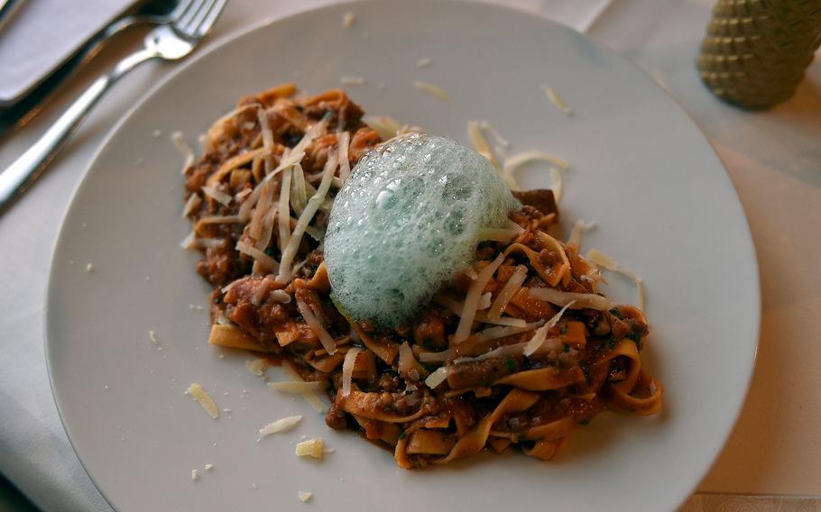 Pasta with a tomato sauce topped with foam.