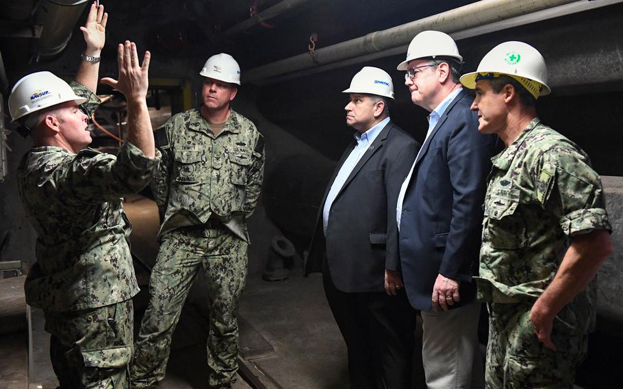 Secretary of the Navy Carlos Del Toro, center, receives a briefing on well operation and recovery initiatives from Capt. Burt Hornyak, commander of Fleet Logistics Center Pearl Harbor, during a tour of the Red Hill well in Aiea, Hawaii, Feb. 26, 2022.