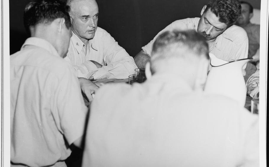 USS Indianapolis commanding officer Capt. Charles B. McVay III tells war correspondents on Guam about the sinking of his ship. 