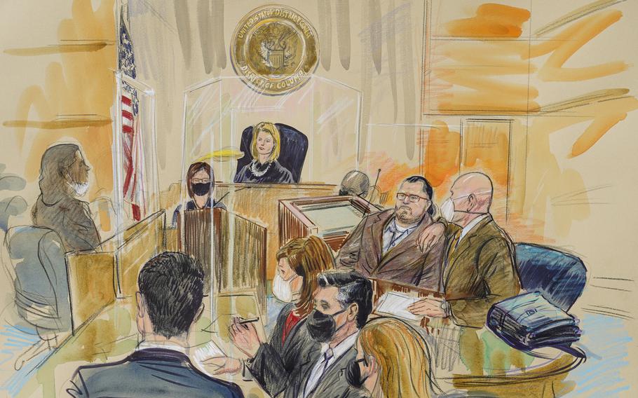This artist sketch depicts Judge Dabney Friedrich looking out from the bench during jury selection for Guy Wesley Reffitt, joined by his lawyer William Welch, top right, in Federal Court, in Washington, Monday, Feb. 28, 2022. S