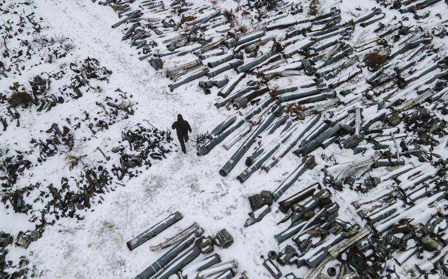 Dmytro Chubenko, spokesman for the Kharkiv chief prosecutor, walks past Russian munitions that devastated much of the area.