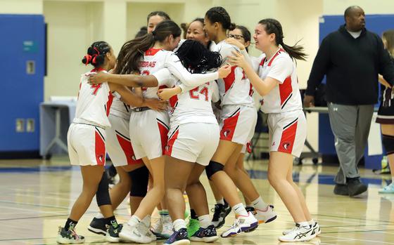 E.J. King's girls basketball team celebrates its 29-28 victory over Zama in the Far East Girls D-II basketball final. The Cobras won their first small-schools title since 1997.