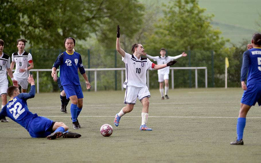 SHAPE's Enrique Jorquera reacts after getting fouled during pool-play action against Wiesbaden on May 15, 2023, in Reichenbach-Steegen, Germany. Sliding into tackle is the Warriors' Ante Dugandzic.