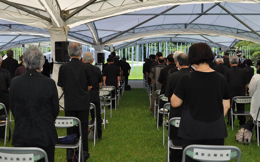 Attendees observe a moment of silence during the island's annual Irei no Hi ceremony at Okinawa Peace Memorial Park in Itoman on June 23, 2022.