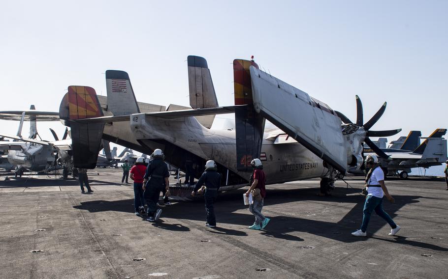 Rescued mariners board a C-2A Greyhound on the flight deck of the Nimitz-class aircraft carrier USS Dwight D. Eisenhower in the Red Sea on Saturday, June 15, 2024.
