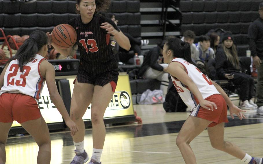 Kinnick's Amyka Jones looks to pass over Okkodo's defense during the Red Devils' 35-17 win Tuesday over the Bulldogs.