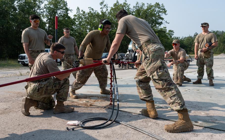 Airmen assigned to the 23rd Combat Air Base Squadron practice fixing a damaged runway in Aplena, Mich., on Aug. 5, 2025, during the two-week Northern Strike military exercise. On Aug. 9, a U.S. Air Force C-130 Hercules assigned to the Mississippi-based 815th Airlift Squadron made a first-of-its-kind landing on a repaired section of runway at the Alpena Combat Readiness Training Center.