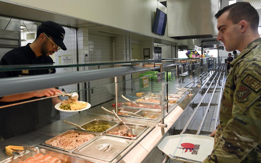 Senior Airman Ryan Scott serves a meal inside the Samurai Cafe Dining Facility at Yokota Air Base, Japan, March 14, 2024. 