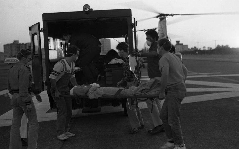 Corpsmen carry a victim on a stretcher.