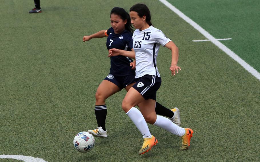 Osan's Jazmine Butalina and Korea International's Marissa Cobb chase the ball during Saturday's Korea girls soccer match. The Phoenix won 6-2.