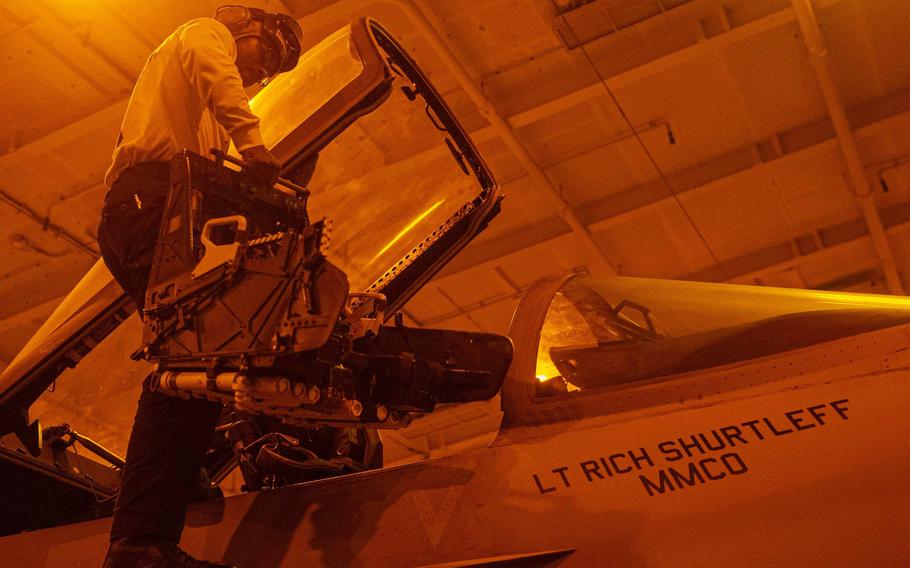 Petty Officer 2nd Class Melvin Beasley, an aviation structural mechanic, installs the seat bucket of an ejector seat into an F/A-18E Super Hornet on the aircraft carrier USS Harry S. Truman in the Arabian Sea in 2019. The Navy announced July 27, 2022  it was replacing a defective component in ejector seats used on some of planes, including the Super Hornet.