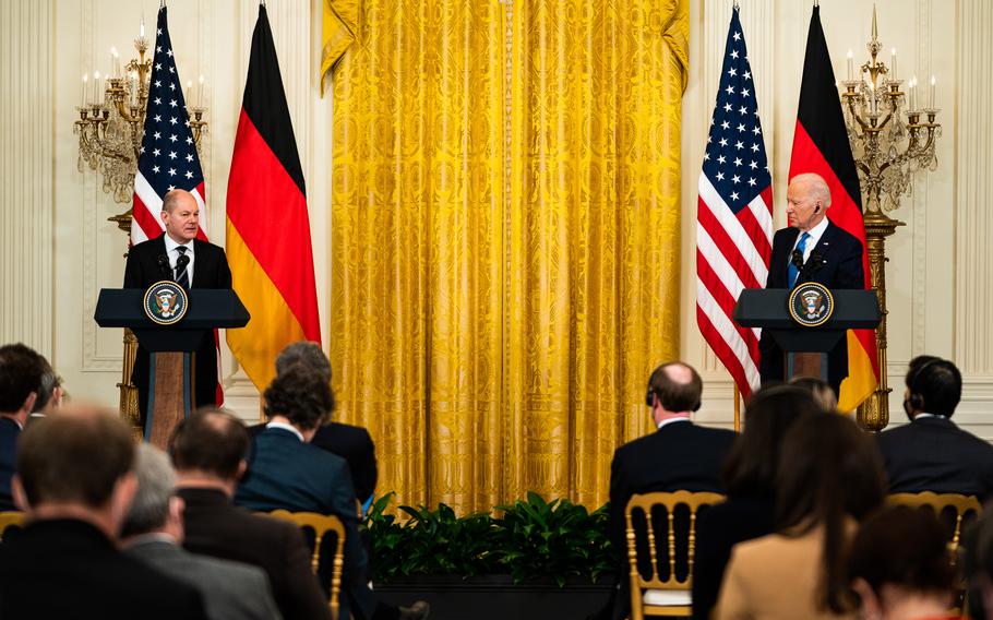 President Biden listens as German Chancellor Olaf Scholz addresses questions during a joint news conference at the White House on Feb. 7, 2022. 