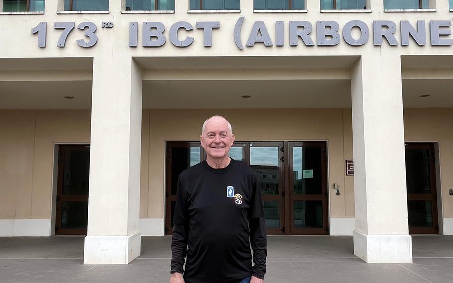 Jim Matchin stands in front of a building that says “173rd IBCT Airborne”