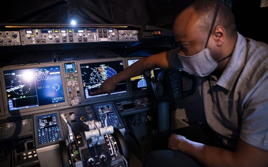 A Boeing employee demonstrates a touch screen control display in the cockpit of a Boeing Co. 737-9 aircraft at Ronald Reagan National Airport in Arlington, Va., on July 28, 2021. 