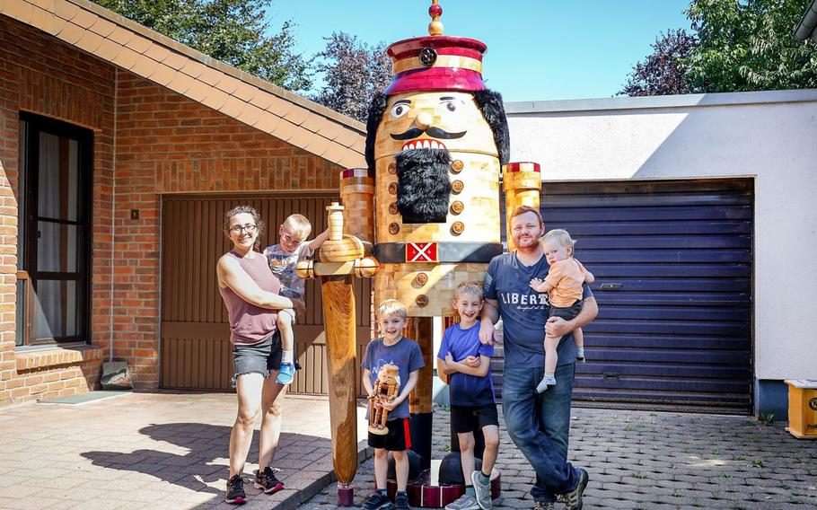 Air Force Capt. John Miller, his wife, Jenna, and kids, left to right, Samuel, Flynn, Davy and Harlan, stand next to the giant nutcracker Miller built while assigned to Geilenkirchen Air Base in Germany. 
