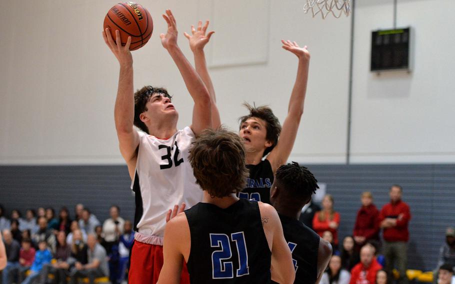 AOSR’s Gabriele Ghione shoots over the Rota defense of Tyler DeMeritt, Brian Leiba and Hampton Brasfield in his team’s 59-51 loss to the Admirals in a Division II semifinal at the DODEA-Europe basketball championships in Ramstein, Germany, Feb. 17, 2023. 