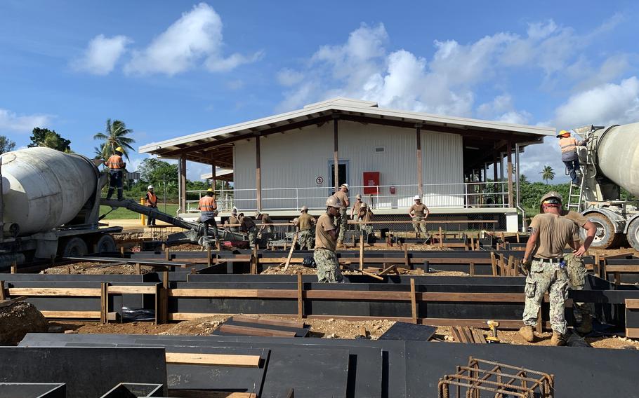 U.S. Navy Seabees with Naval Mobile Construction Battalion 5 place concrete during construction of a dental facility at Lombrum Naval Base, Papua New Guinea, Nov. 17, 2021.