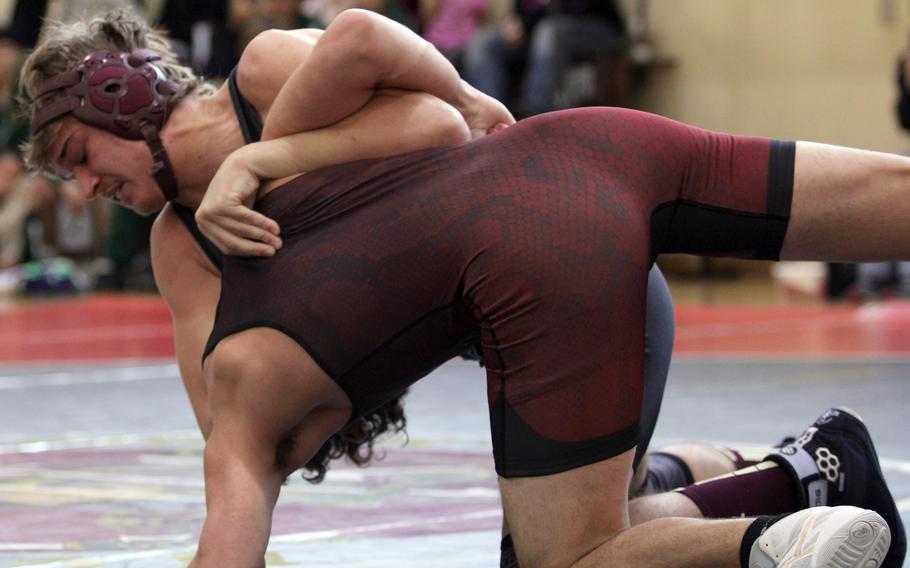 Matthew C. Perry's Kirby Kendrick gains the edge on E.J. King's Jackson Pavkov at 158 pounds during Saturday's DODEA-Japan wrestling openers. Kendrick pinned Pavkov and the Samurai edged the Cobras 30-29.