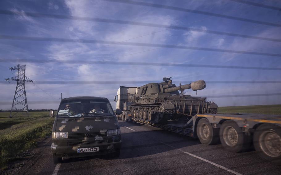 A truck transports a platform with a Ukrainian self-propelled artillery vehicle in Donetsk region, Ukraine, on Thursday, May 12, 2022. 
