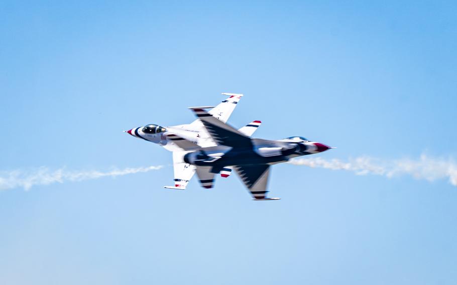 Two U.S. Air Force Thunderbirds perform a maneuver in the air