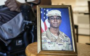 FILE - A portrait of American soldier Travis King is displayed as his grandfather, Carl Gates, talks about his grandson on July 19, 2023, in Kenosha, Wis. The Biden administration is extending for another year a ban on the use of U.S. passports for travel to North Korea, the State Department said Tuesday. The latest extension comes as tensions with North Korea are rising over its nuclear and ballistic missile programs and the uncertain status of Travis King, a U.S. service member who last month entered the country through its heavily armed border. (AP Photo/Morry Gash, File)