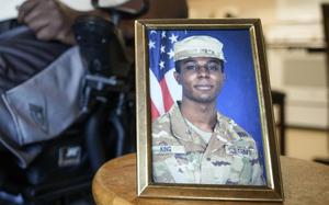 FILE - A portrait of American soldier Travis King is displayed as his grandfather, Carl Gates, talks about his grandson on July 19, 2023, in Kenosha, Wis. The Biden administration is extending for another year a ban on the use of U.S. passports for travel to North Korea, the State Department said Tuesday. The latest extension comes as tensions with North Korea are rising over its nuclear and ballistic missile programs and the uncertain status of Travis King, a U.S. service member who last month entered the country through its heavily armed border. (AP Photo/Morry Gash, File)