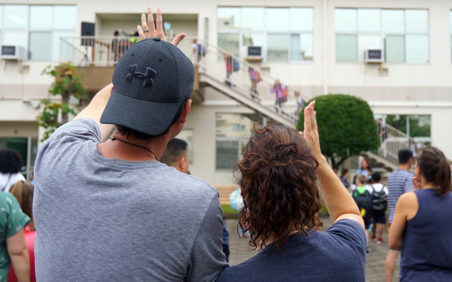 Parents see off their child on the first day of classes at Sullivans Elementary School on Yokosuka Naval Base, Japan, Monday, Aug. 22, 2022.
