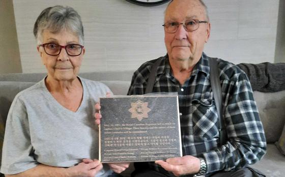 Elizabeth MacHardy and Gordon Strachan hold a plaque commemorating Canadians killed in the Korean War. Their brother, Pvt. William Leslie Strachan, was one of the six who died on Hill 467 in the battle for Chail-li Village.