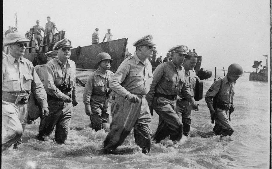 Army Gen. Douglas MacArthur wades ashore during initial landings at Leyte, Philippines, in October 1944.