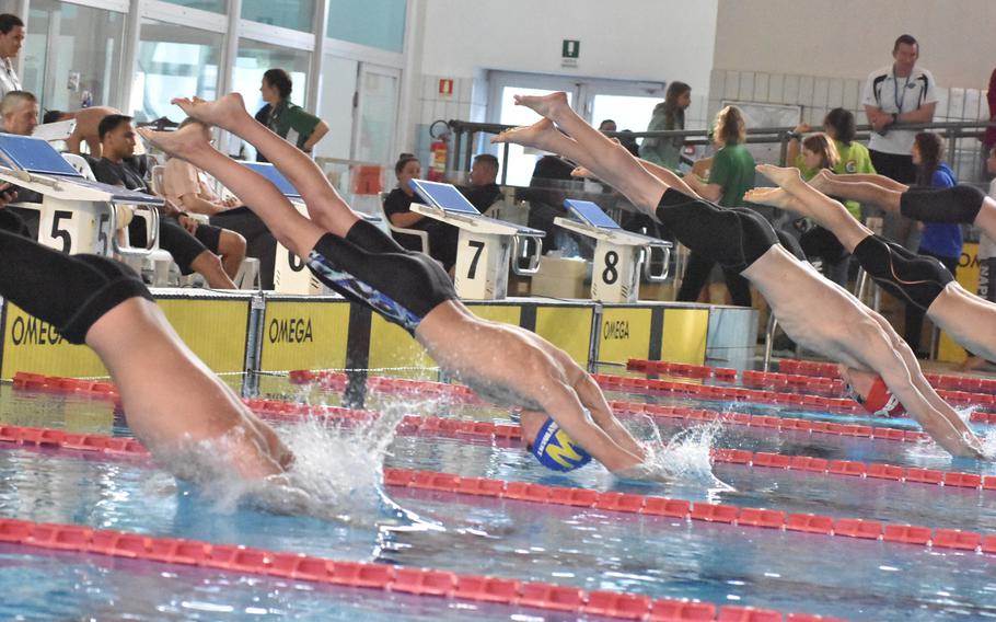 Boys dive into the pool during an 800-meter freestyle heat at the European Forces Swim League Long Distance Championships on Saturday, Nov. 26, 2022, at Lignano Sabbiadoro, Italy.