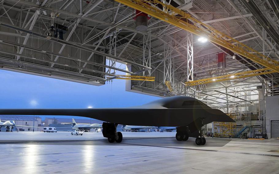Artist rendering of a B-21 Raider in a hangar is seen with the background being Ellsworth Air Force Base, South Dakota, one of the future bases to host the new airframe. 