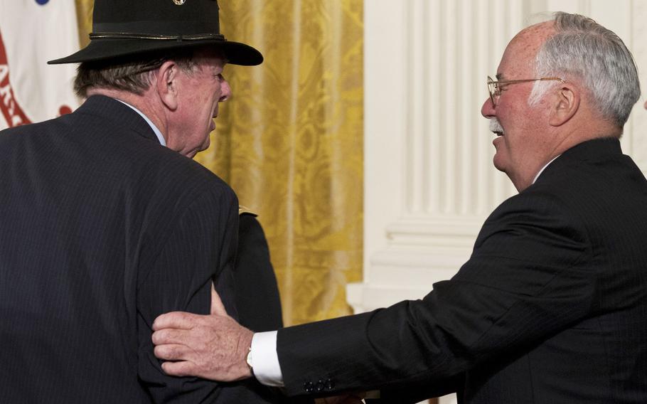 Joe Galloway is greeted by Medal of Honor recipient Harvey "Barney" Barnum before a ceremony at the White House in 2007.