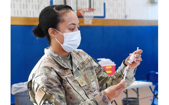 Master Sgt. Cherie Gregory, 66th Medical Squadron functional manager, prepares a vaccine during a point of distribution at Hanscom Air Force Base, Mass., Nov. 9. The clinic offered the influenza and COVID vaccinations during the POD for all eligible personnel 12 and older including service members, dependents, federal civilians, defense contractors, and retirees. (U.S. Air Force photo by Linda LaBonte Britt)