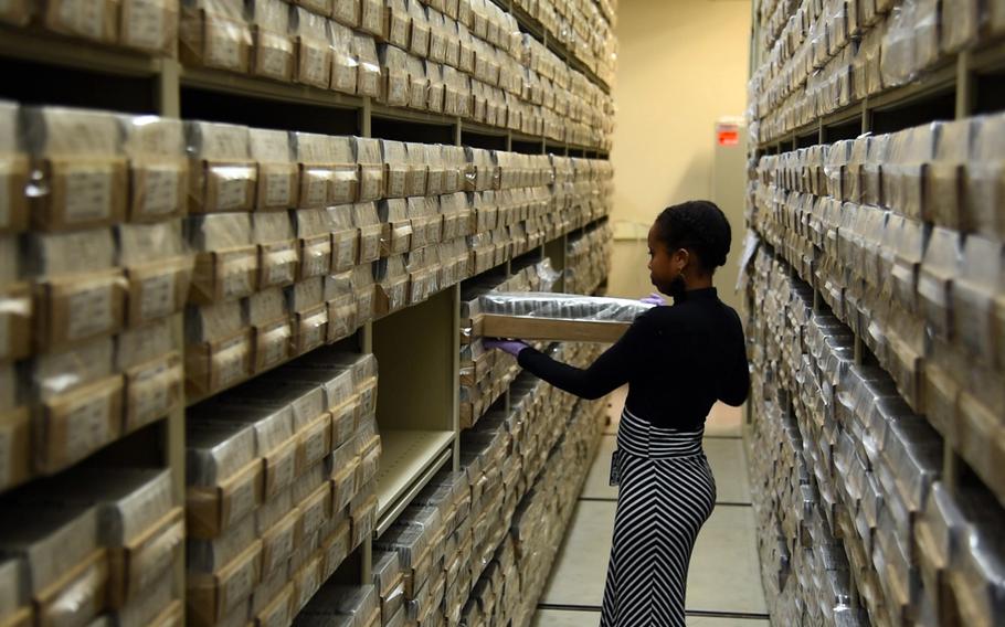 A worker removes a container of blood-sample cards at the Armed Forces Repository of Specimen Samples for the Identification of Remains at Dover Air Force Base, Del., Jan. 30, 2019.