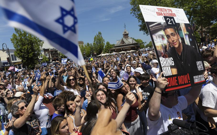 A crowd cheers the release of Edan Alexander.