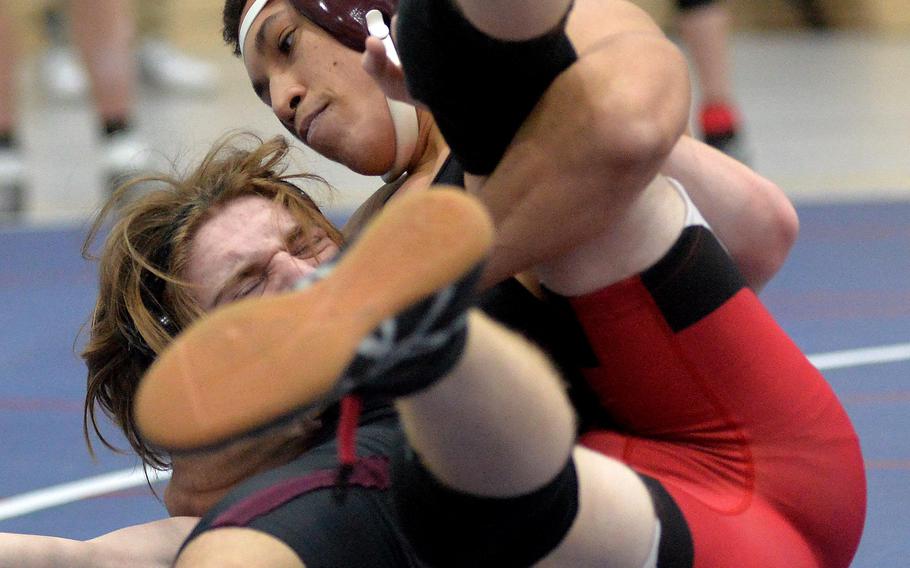 Vilseck’s Zephanyah Barnes, right, has a grip on Kaiserslautern’s Noah Crowell in a 132-pound match in opening day action at the high school 2022 Wrestling Tournament in Ramstein. Barnes won the match.