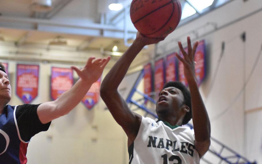 Naples' Chris White ties the score against Aviano late in the game Saturday, Jan. 7, 2023, but the Saints went on to a 56-50 victory.