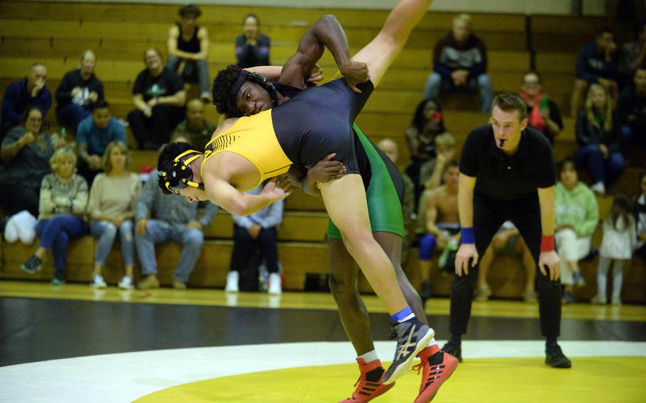 Kubasaki’s Godfrey Wray lifts Kadena’s Jayden Guevara at 141 pounds during Wednesday’s Okinawa wrestling dual meet. Wray won by pin in 2 minutes, 7 seconds and the Dragons took the meet 40-23.