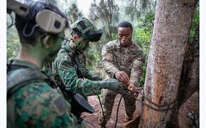 Members of the 25th Infantry Division train side by side with Singapore Armed Forces partners on May 11, 2023 during Tiger Balm 23 on the steep Hawaiian mountainsides, deep in the jungle. 
