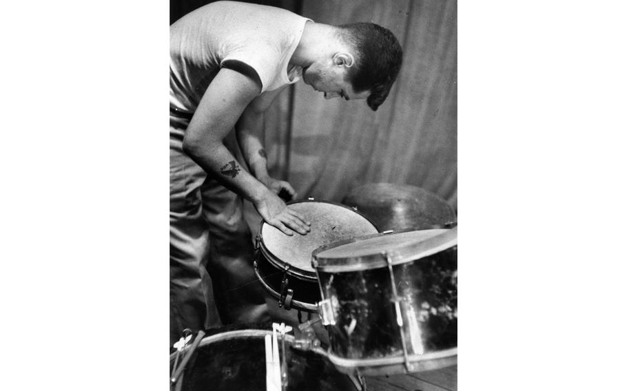 A "band member" of the 7th Infantry Division Special Services checks the drums.