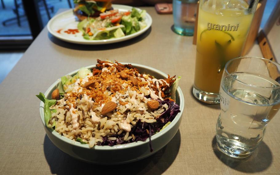 In the foreground is the Tiger Bowl and the pina y gato, a coconut pineapple mint lemonade, and in the background is the “Cheezeburger” at the Katzentempel restaurant in Trier, Germany, June 8, 2024.