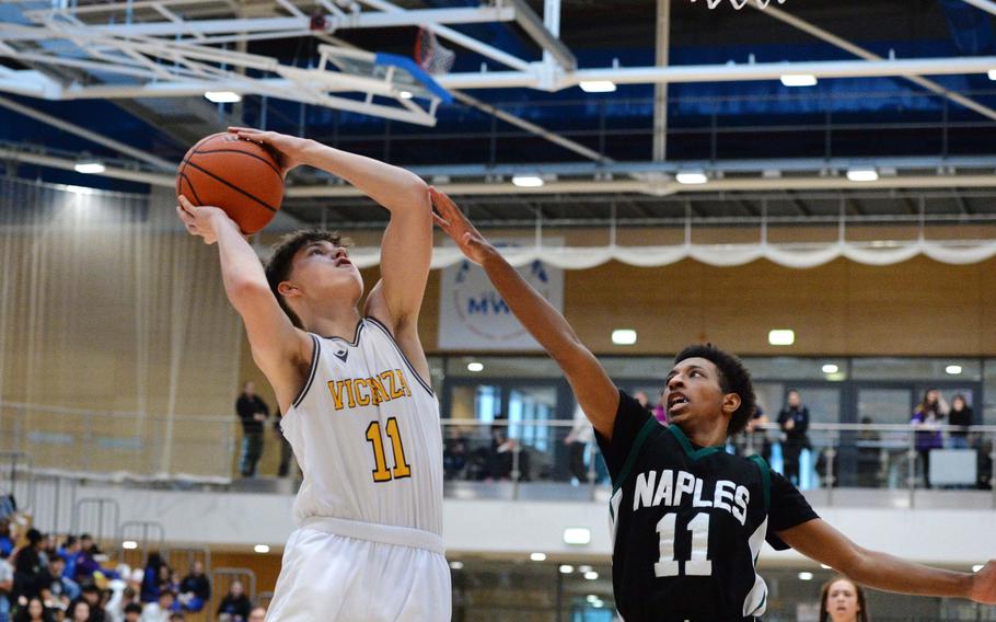 Vicenza’s Ben Harlow goes to the basket against Naples’ Davion Bowie  in the boys Division II final at the DODEA-Europe basketball championships in Wiesbaden, Germany, Feb. 17, 2024. Vicenza beat Naples 76-37 to capture the title.