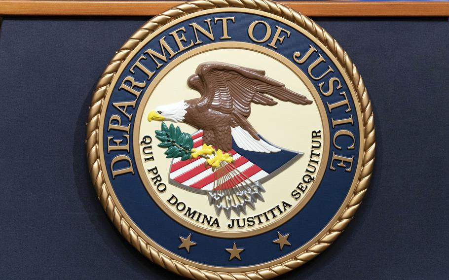 The Department of Justice seals is seen during a news conference at the DOJ office in Washington, May 16, 2023.