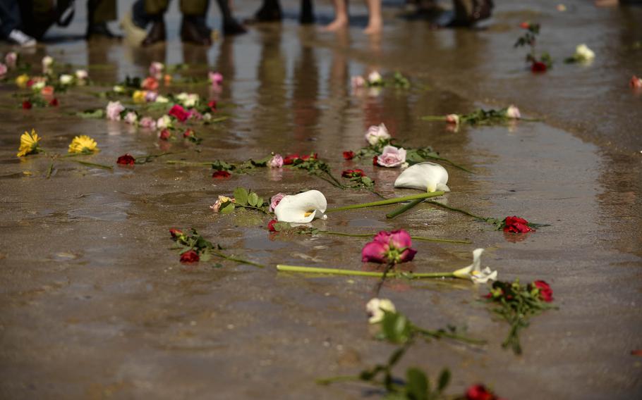 Roses lie in sand at Omaha Beach in Ste-Laurent-sur-Mer, France, to remember the women who served during the D-Day invasions during the 70th D-Day anniversary commemorations June 7, 2014. 